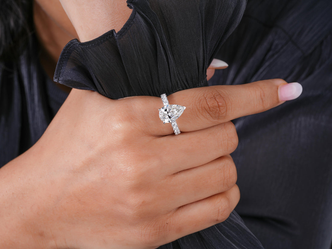 pear engagement ring in round cut pave band style.
