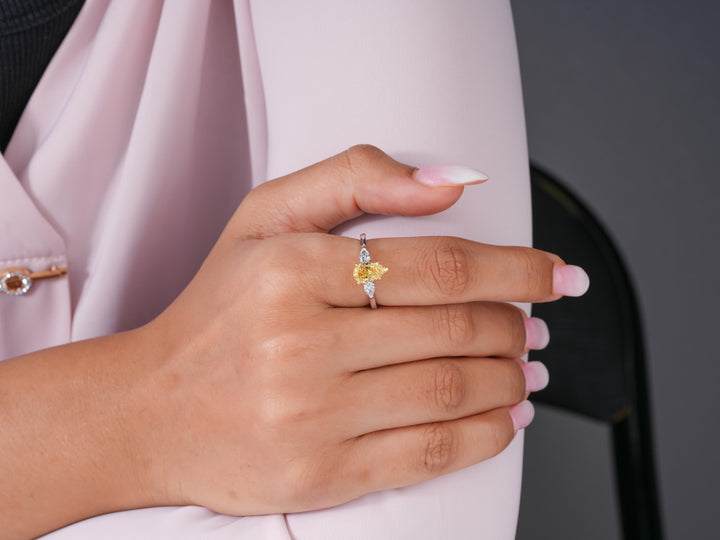 pear diamond 3 stone ring with yellow diamond ring.
