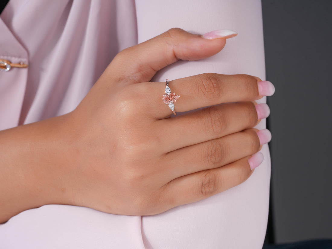 pear pink stone ring in three stone ring style.
