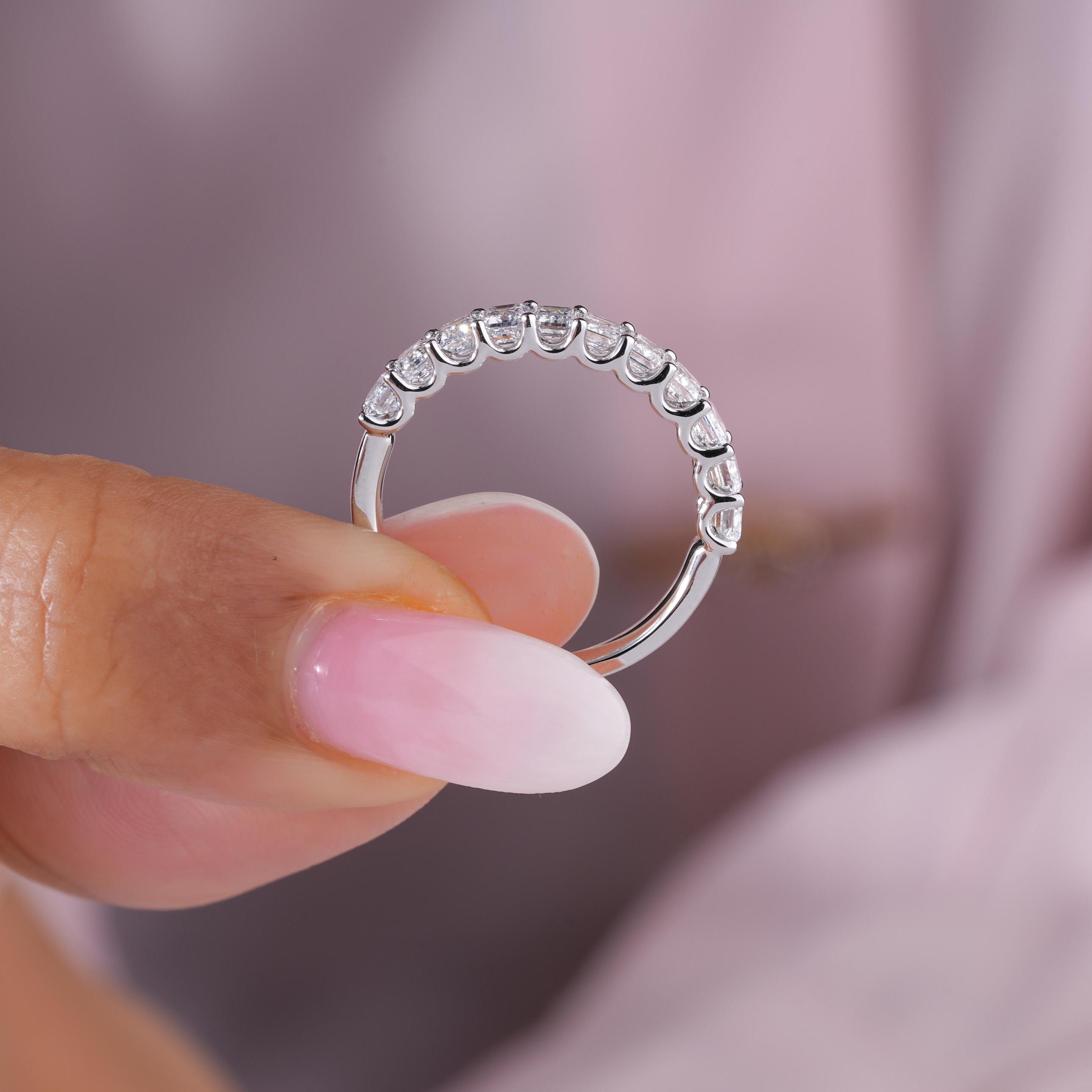 Half eternity band featuring an emerald half eternity band.

