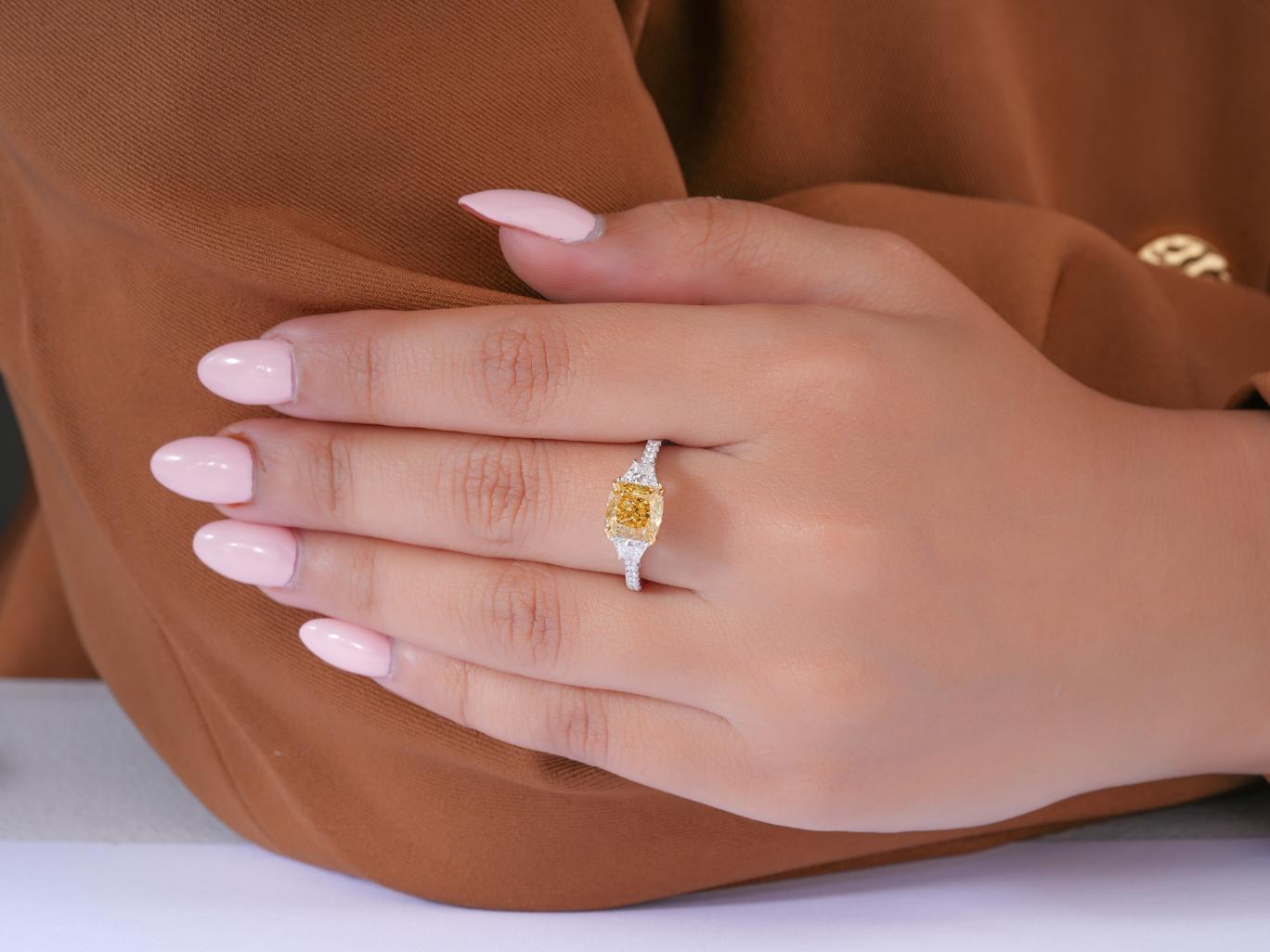 yellow diamond cushion ring with 4 claw prong.

