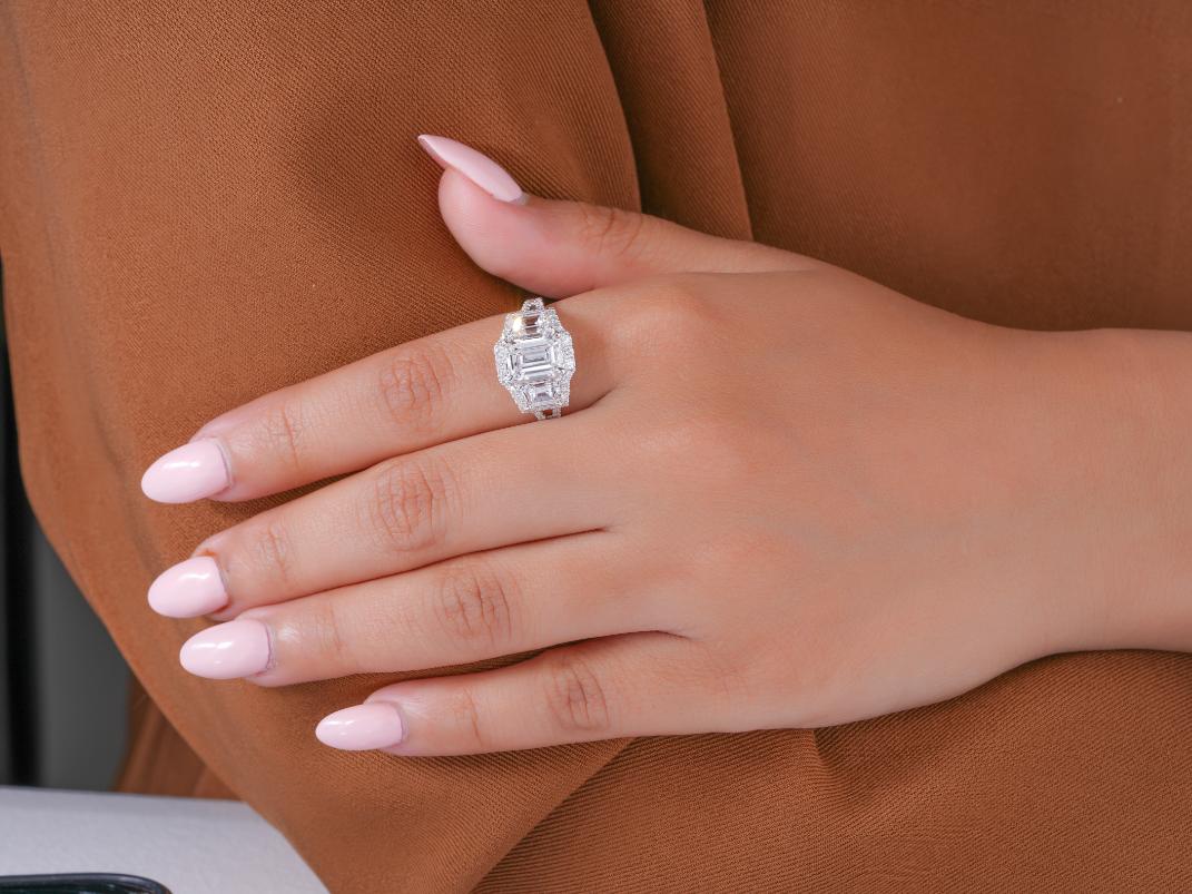 three stone diamond ring in trapezoid side stone style.
