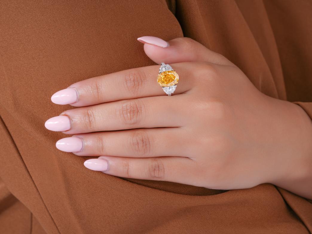 yellow oval cut ring in pave setting ring style.
