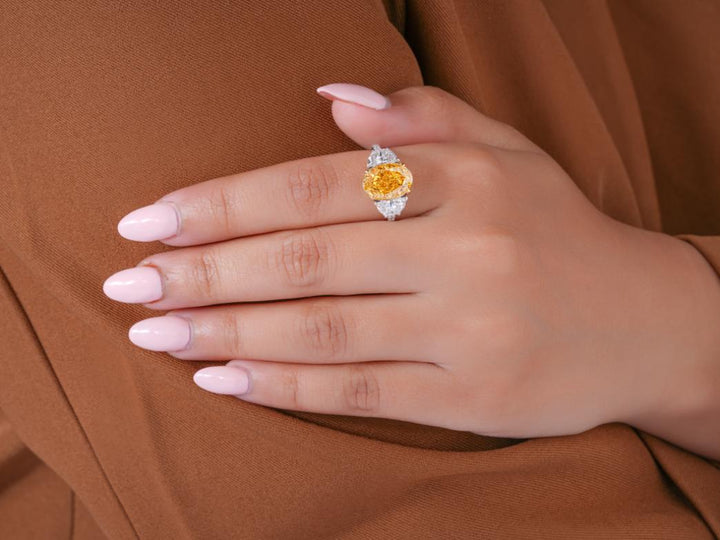yellow oval cut ring in pave setting ring style.
