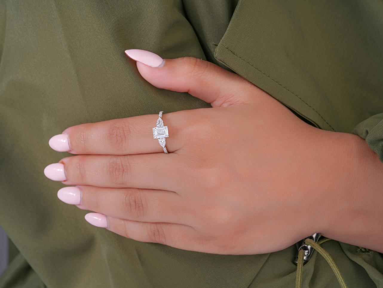 trilogy engagement ring on solid gold ring.
