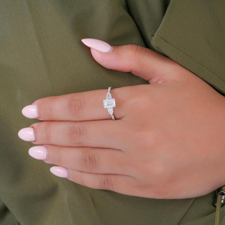 trilogy engagement ring on solid gold ring.
