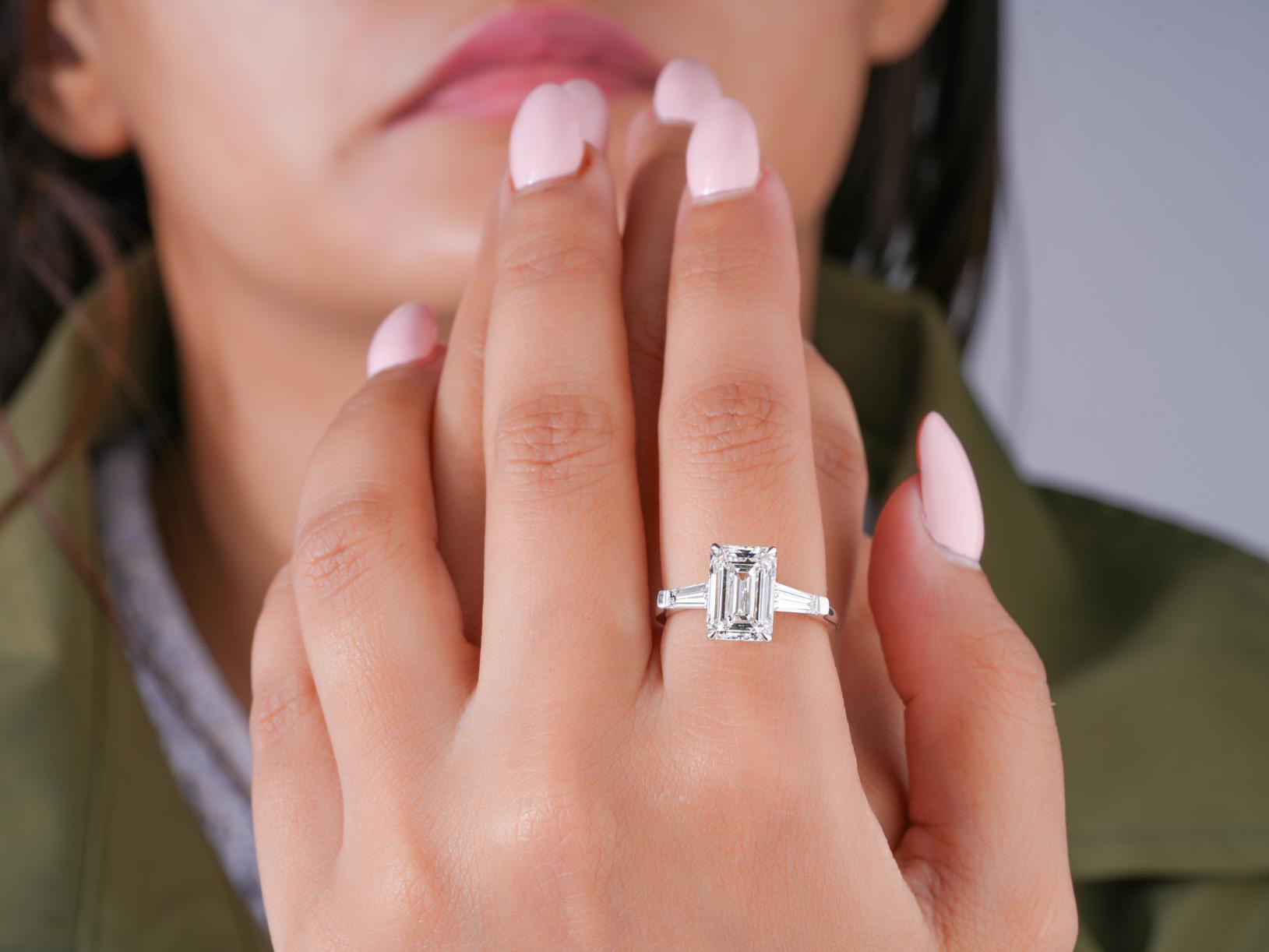 trilogy diamond ring in tapered baguette side stone style.
