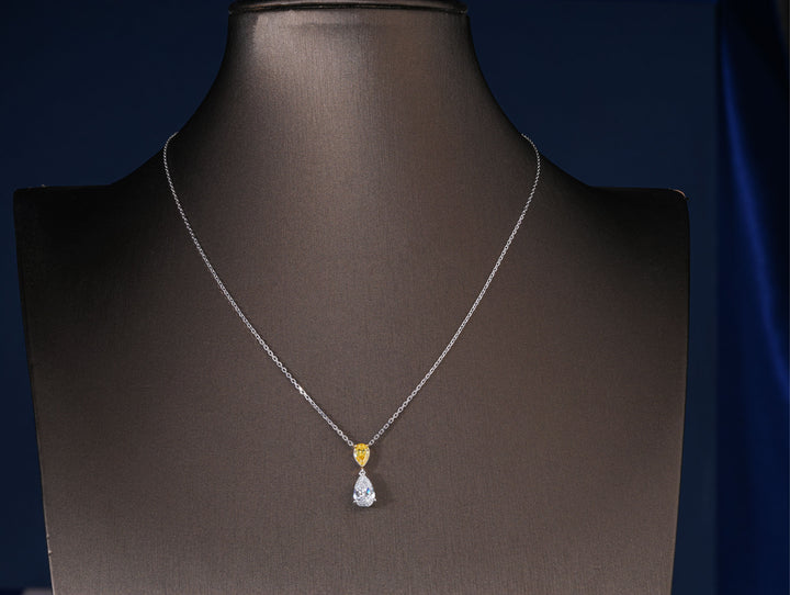 yellow pear diamond with two tone gold pendant.
