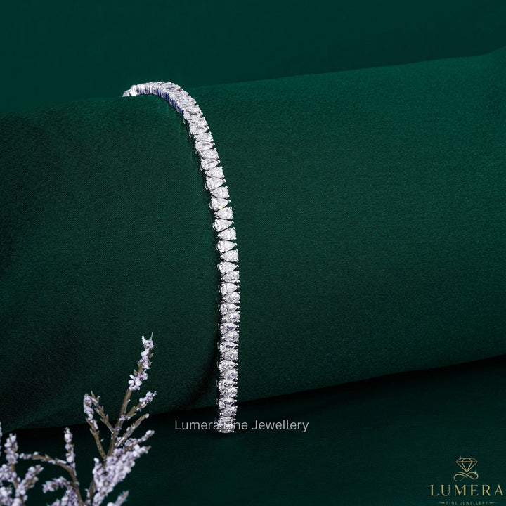 solid gold bracelet with pear diamond line bracelet.
