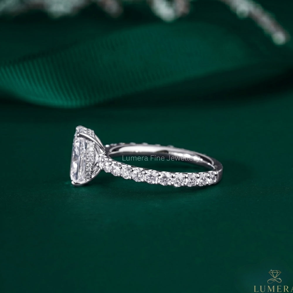 elongated cushion cut engagement ring on pave setting ring.
