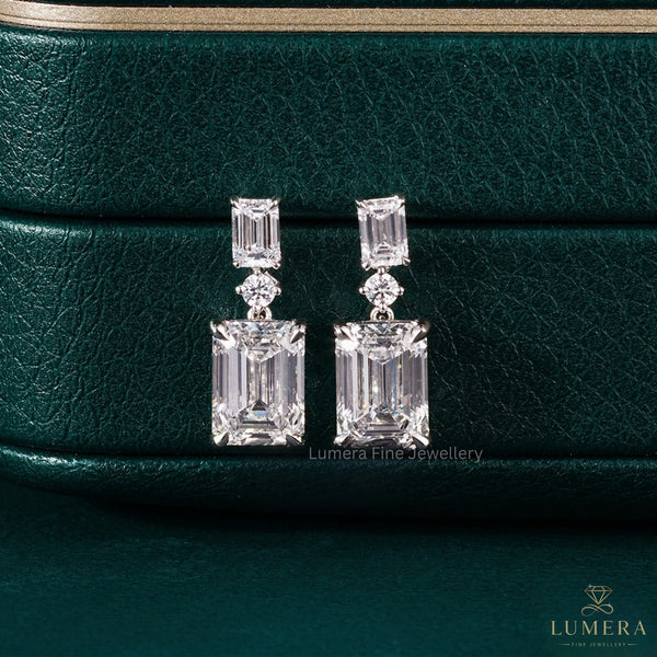 emerald drop earrings with claw prong setting.
