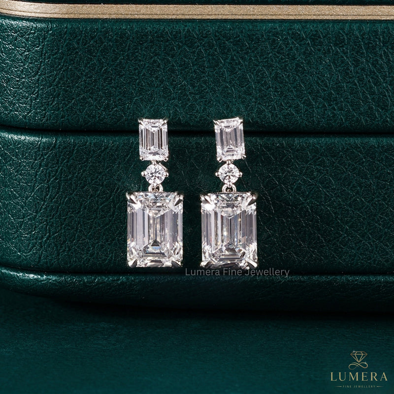emerald drop earrings with claw prong setting.
