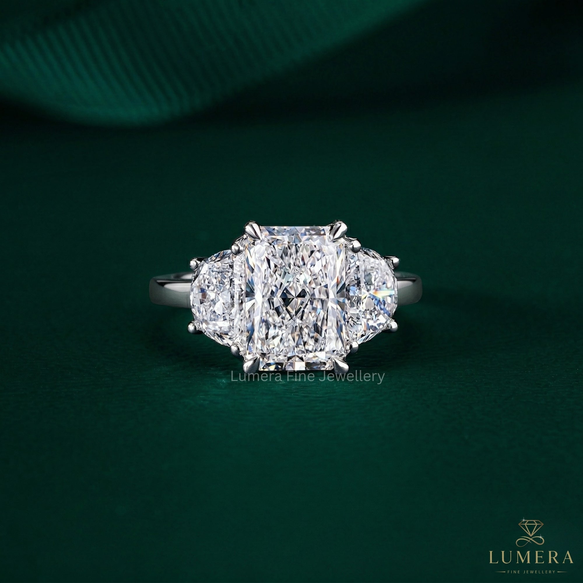 three stone diamond engagement ring with radiant cut ring.
