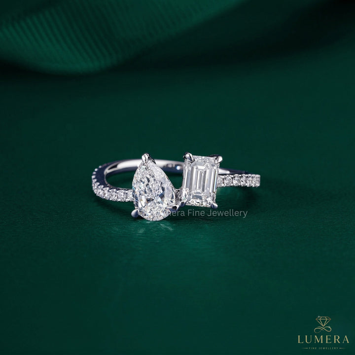 toi et moi engagement ring with pear and emerald cut ring.
