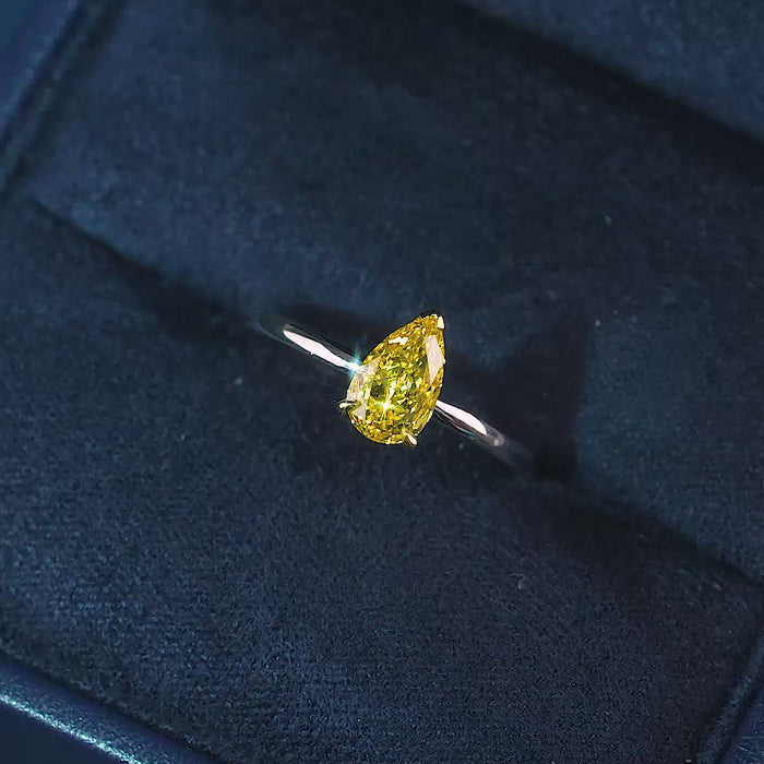 yellow diamond pear cut ring in v prong set style.
