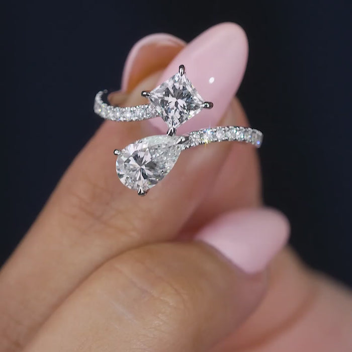 pear engagement ring with princess diamond ring.
