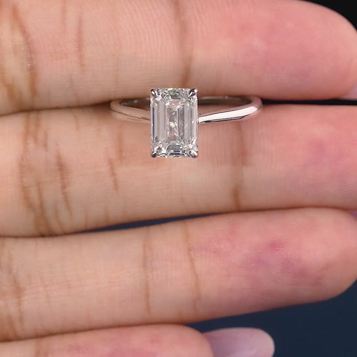 emerald cut engagement ring on cathedral set ring.
