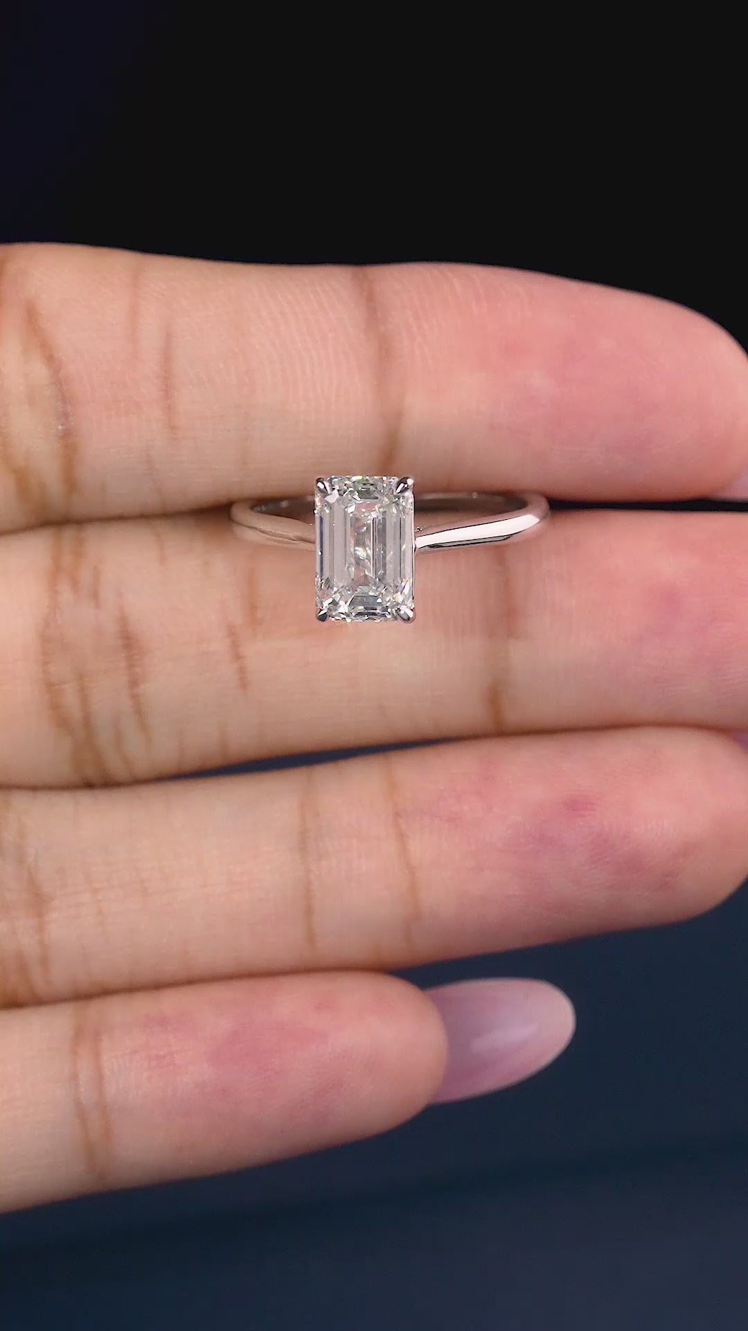 emerald cut engagement ring on cathedral set ring.
