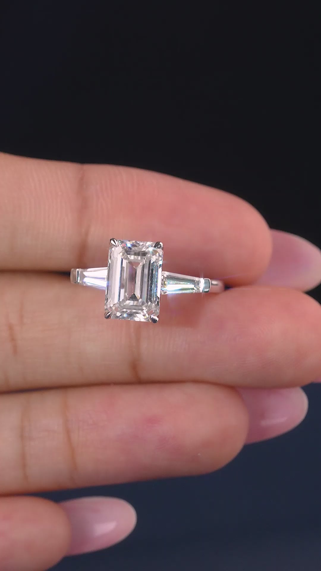 emerald cut engagement ring with trilogy diamond ring.
