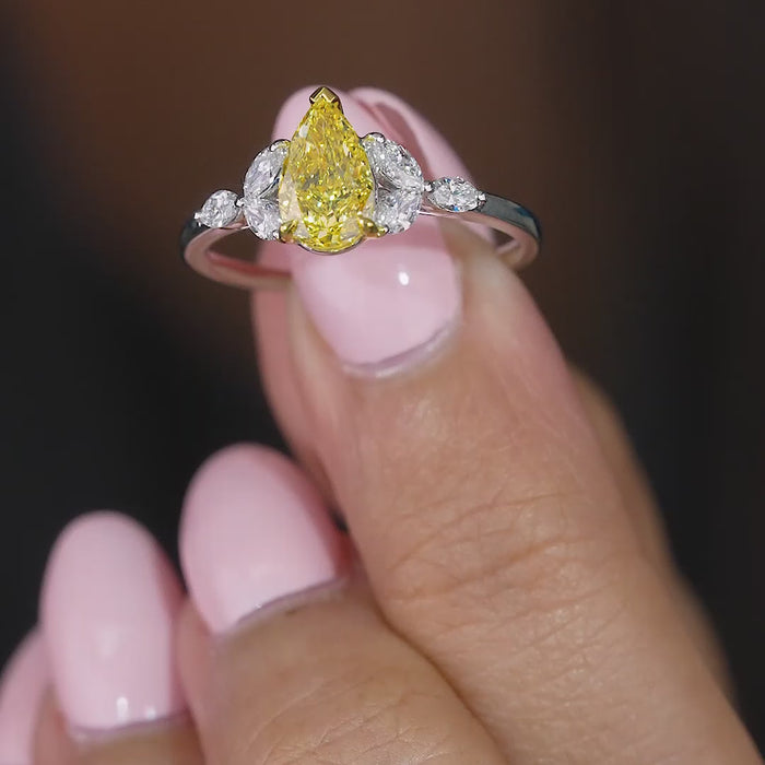 yellow pear diamond ring with prong setting.
