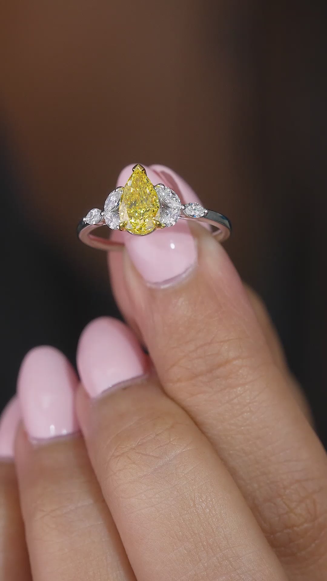 yellow pear diamond ring with prong setting.
