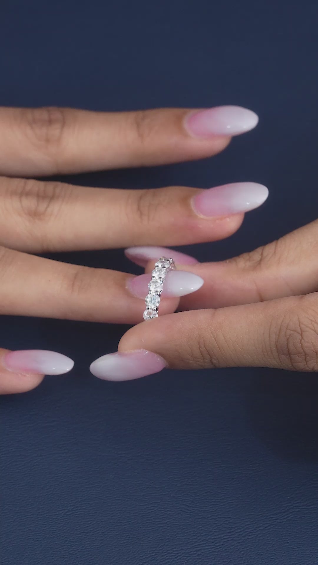 round diamond wedding band on shared prong setting.
