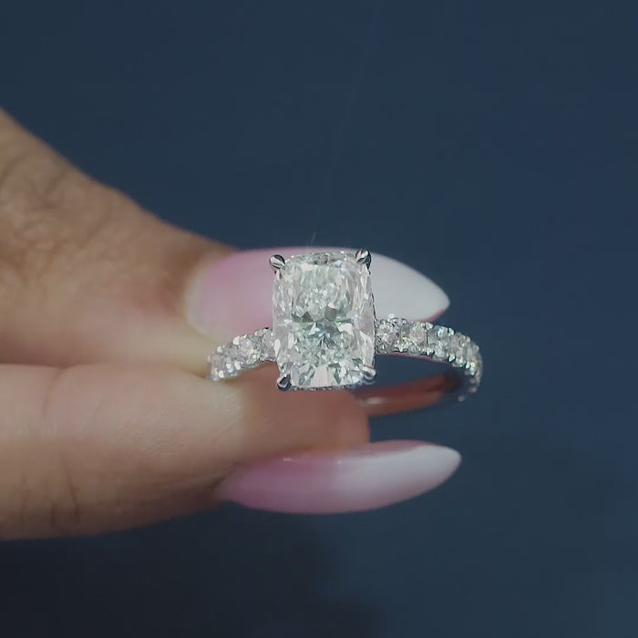 elongated cushion cut engagement ring on pave setting band ring.
