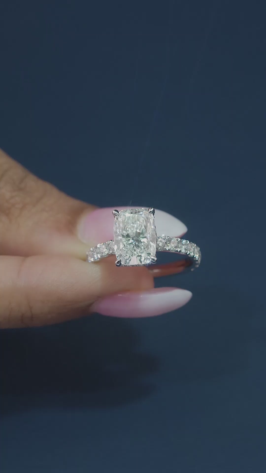 elongated cushion cut engagement ring on pave setting band ring.
