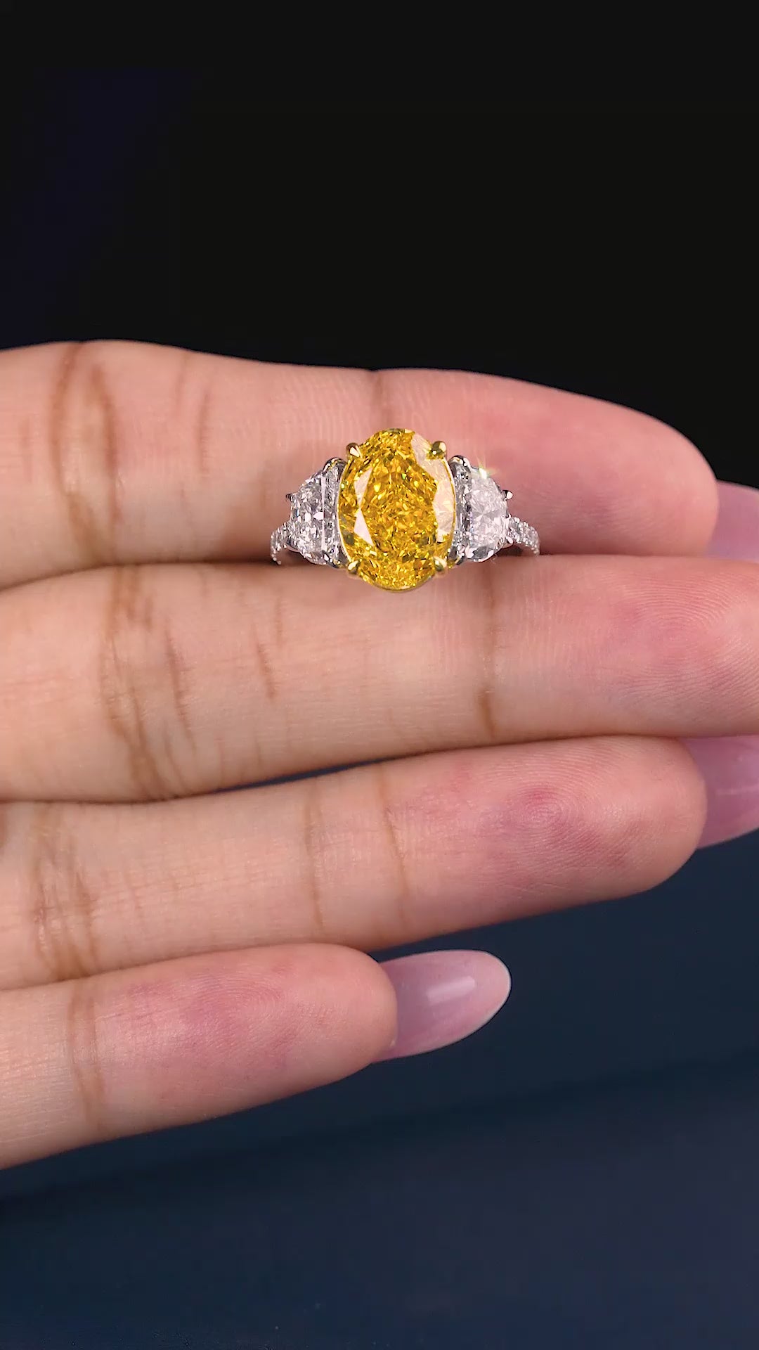 yellow diamond ring with half moon cut side stone.
