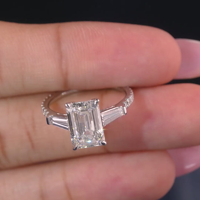 emerald cut engagement ring on pave set band.
