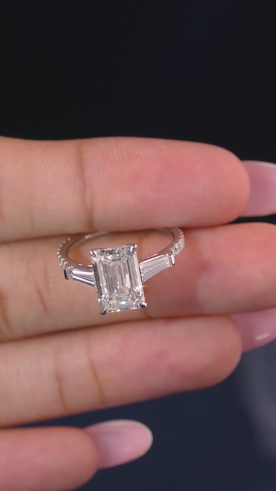 emerald cut engagement ring on pave set band.
