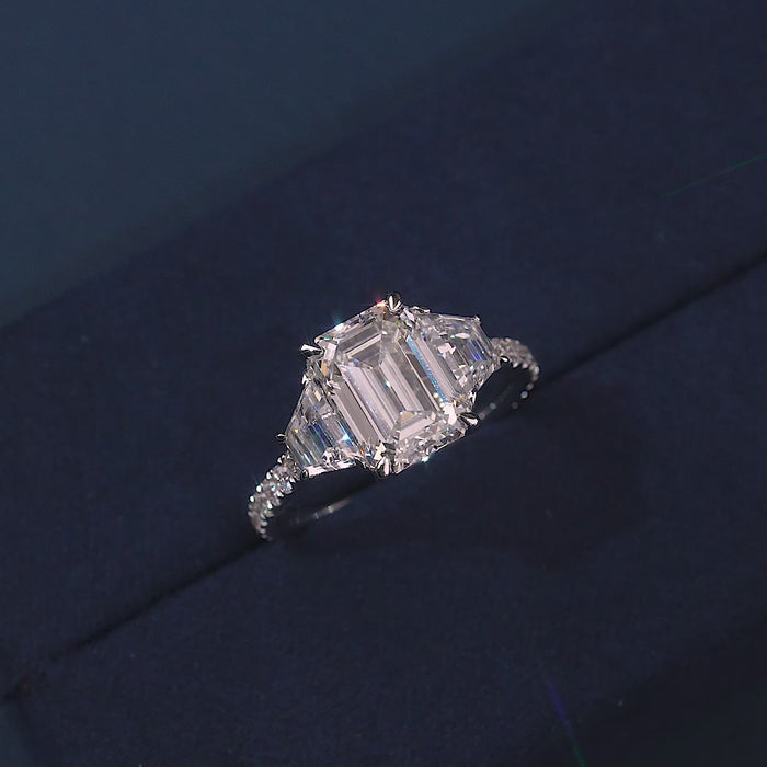 emerald diamond ring with trapezoid side stones.
