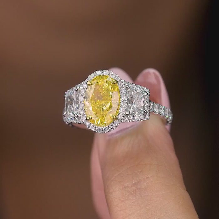 fancy yellow diamond ring on oval diamond engagement ring.
