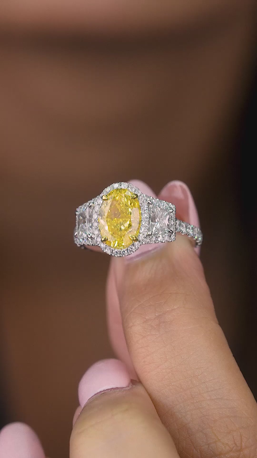 fancy yellow diamond ring on oval diamond engagement ring.
