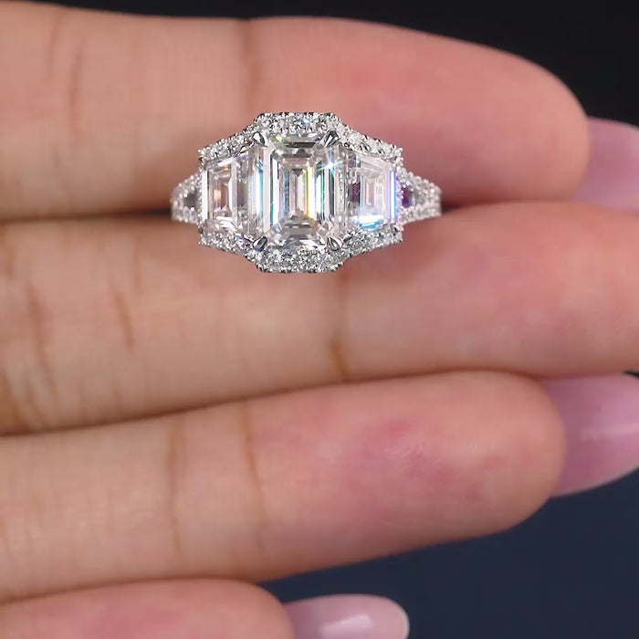 emerald cut three stone ring with pave set band.
