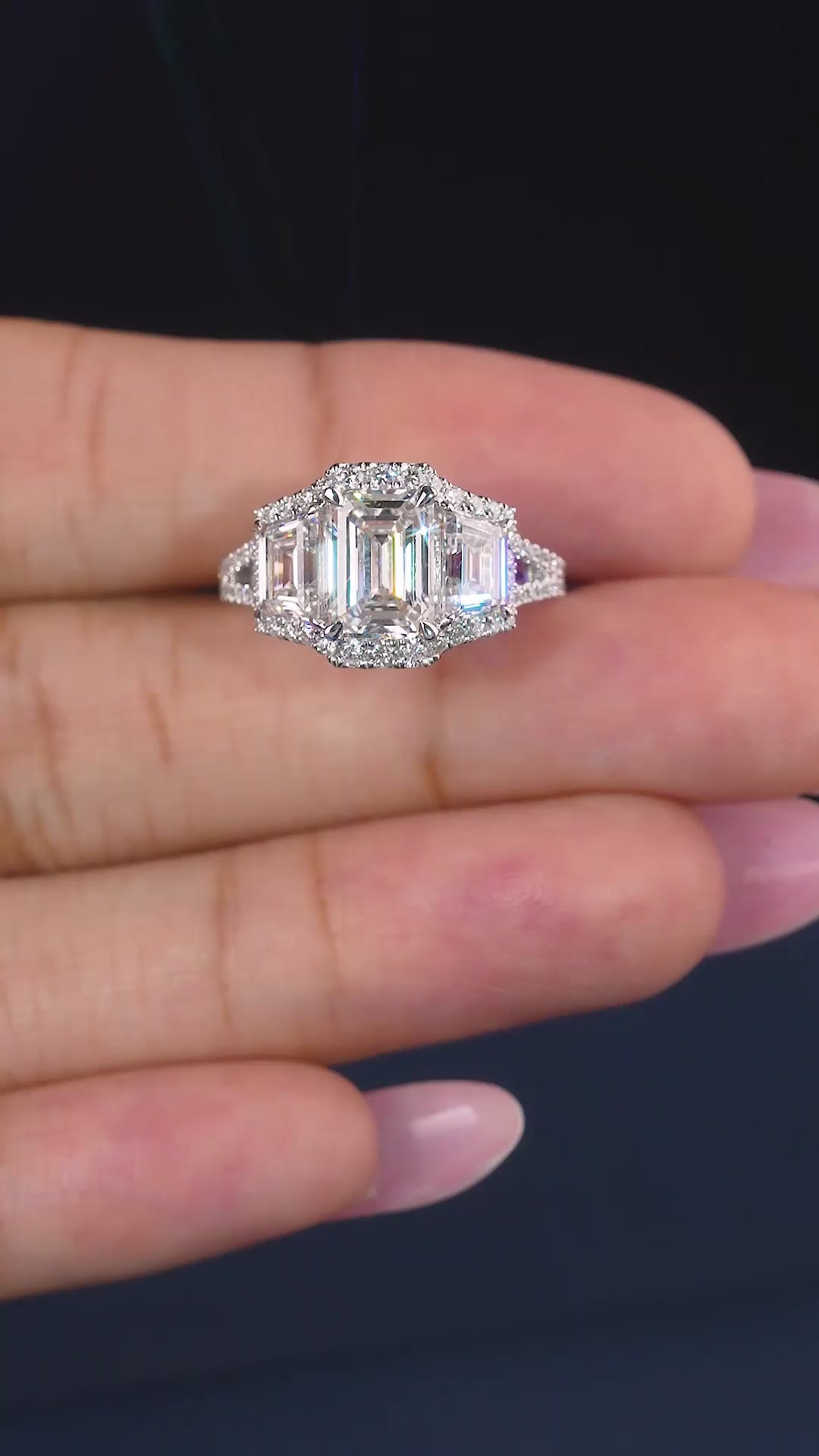 emerald cut three stone ring with pave set band.
